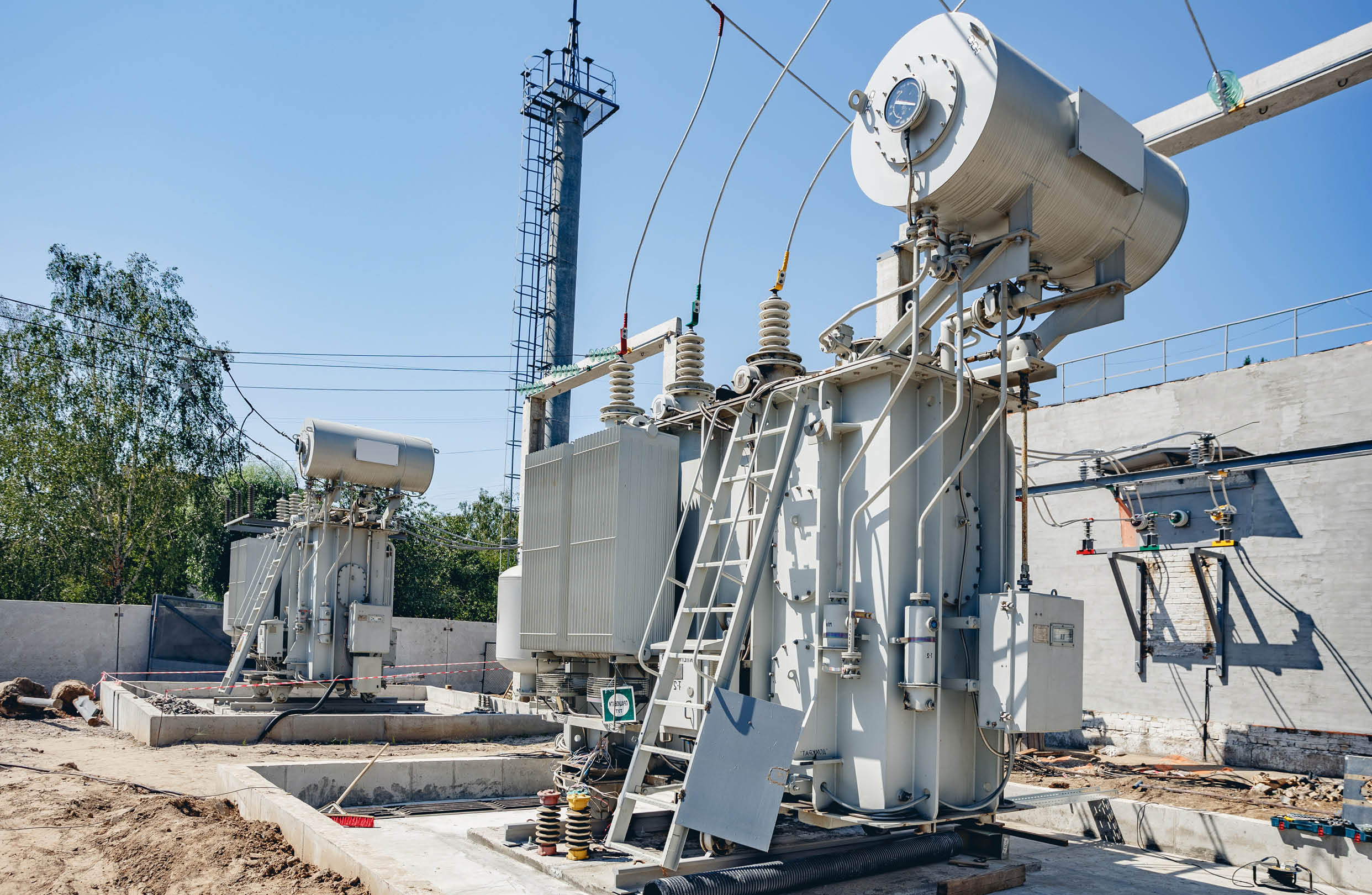 High-voltage substation on blue sky background with switch