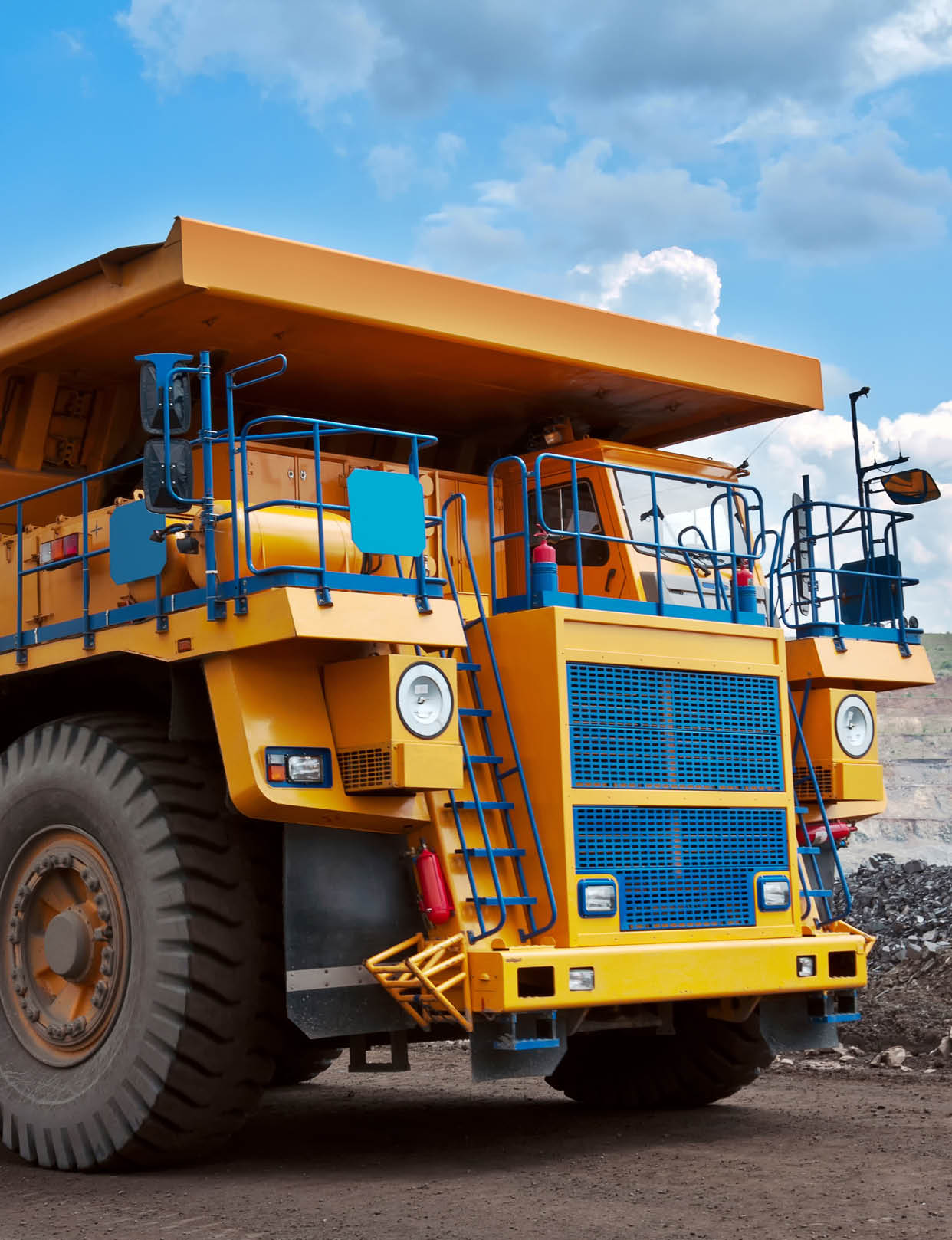 A picture of a big yellow mining truck at worksite
