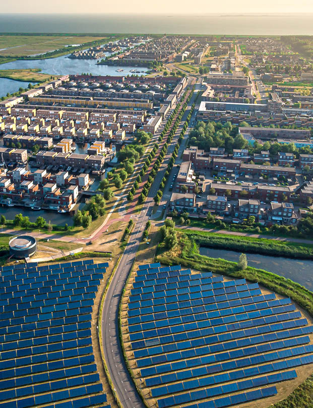 Modern sustainable neighbourhood in Almere, The Netherlands. The city heating (stadswarmte) in the district is partially powered by a solar panel island (Zoneiland). Aerial view.