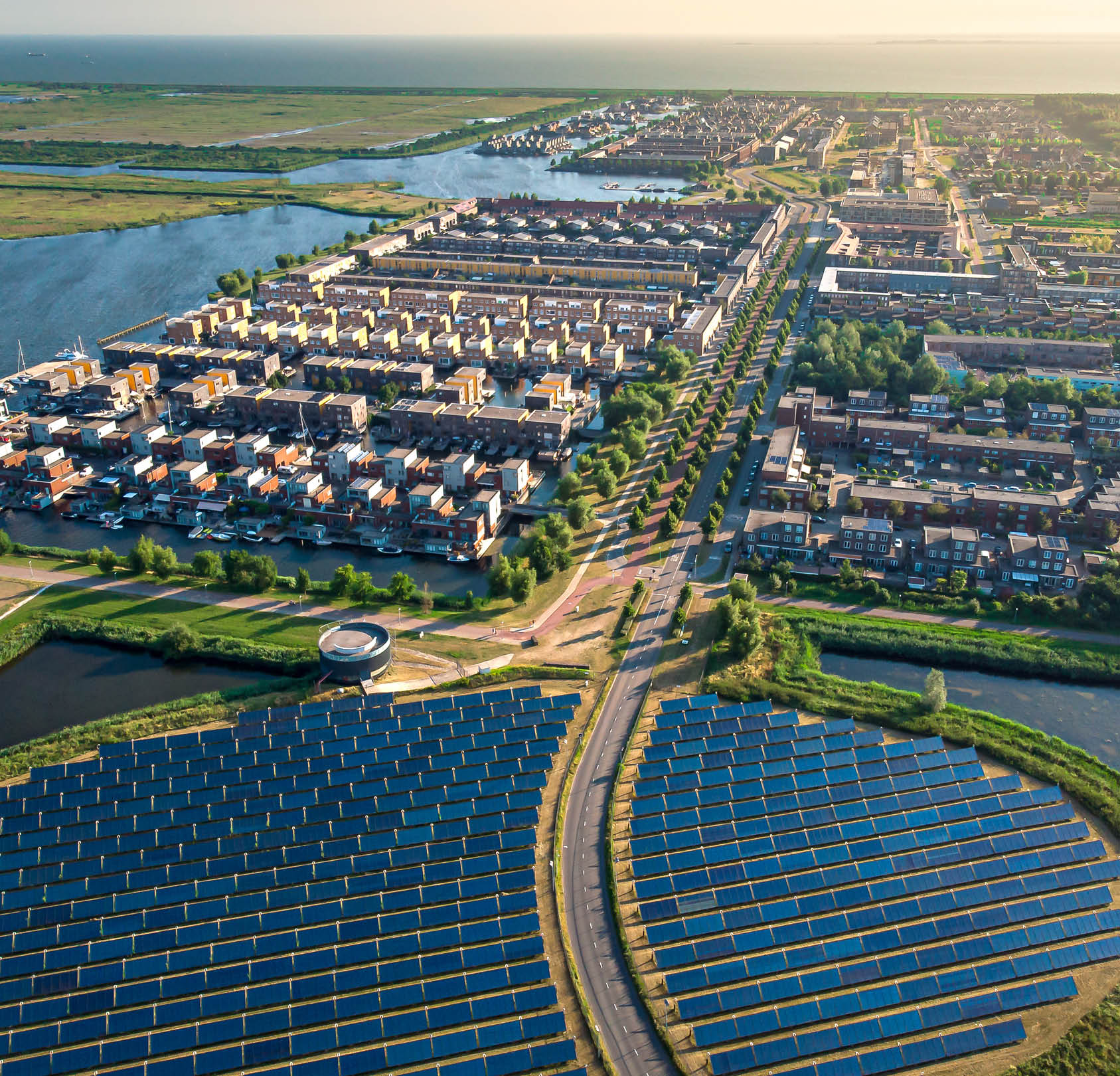 Modern sustainable neighbourhood in Almere, The Netherlands. The city heating (stadswarmte) in the district is partially powered by a solar panel island (Zoneiland). Aerial view.